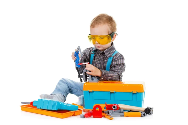 Happy little boy with tools on white background — Stock Photo, Image