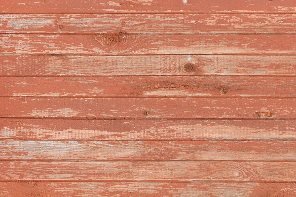 Zázemí staré dřevěné desky popraskané červenou barvou — Stock fotografie