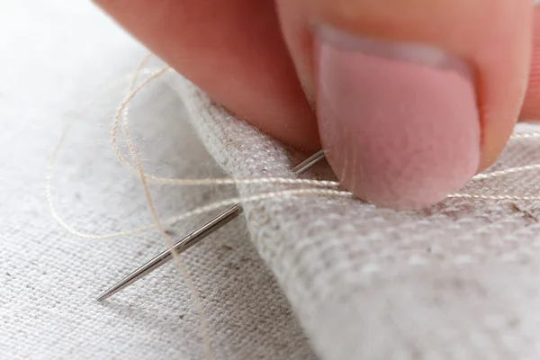 Lien fabric with needle and thread Stock Image