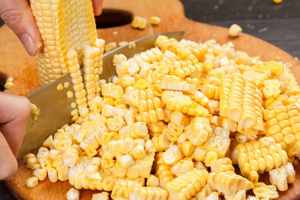 Chef-kok snijden maïs voor het koken. Stock-up op winter voedsel. — Stockfoto