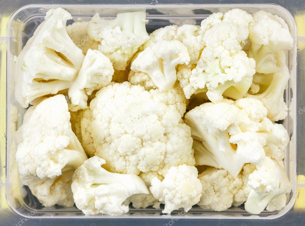 Tray with raw cauliflower for freezing. Stock Photo by ©BravissimoS