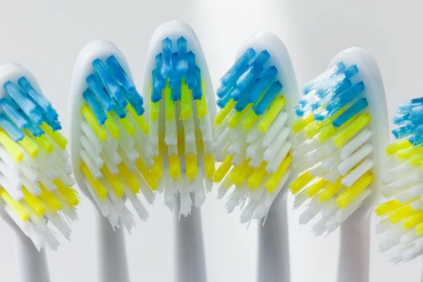 Group of colorful toothbrushes over white — Stock Photo, Image
