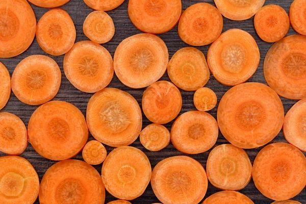 Sliced carrot on a wooden background. Top view.