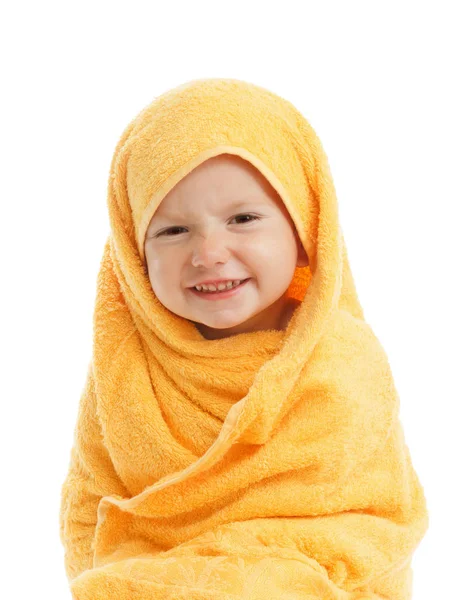 Happy baby wearing yellow towel sitting after bath or shower. — Stockfoto