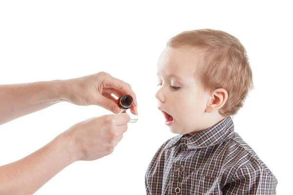 Mor ger medicin sirap unga barn pojke, på vitt — Stockfoto
