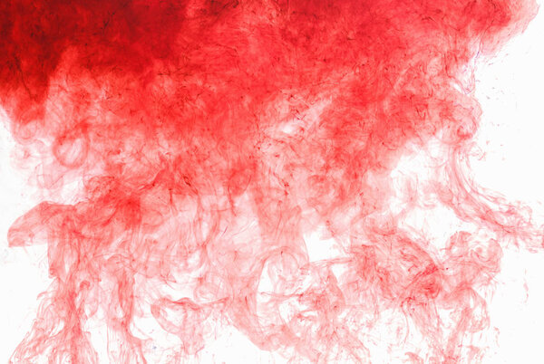 Abstract background. Red ink in water, in motion. Color drop swirling. Colorful cloud of paint on white.