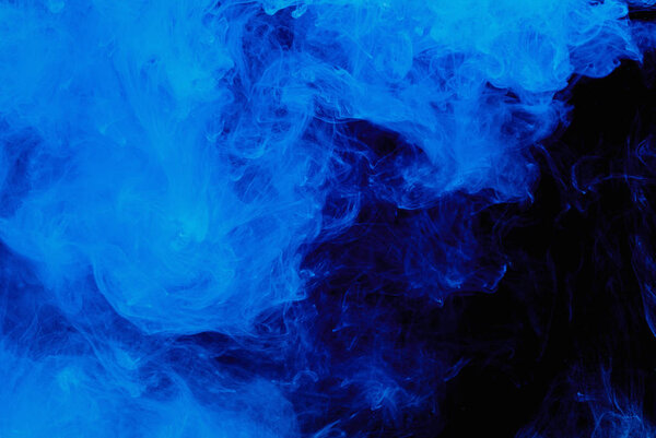 Abstract blue cloud pattern of white smoke on a black background.
