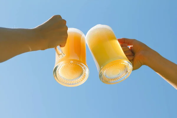 People clink beer. Royalty Free Stock Photos