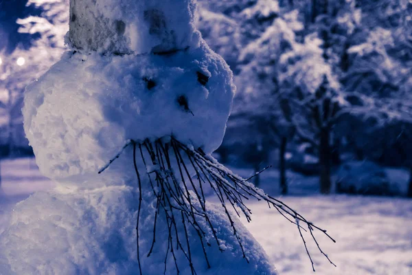 Angry, sad snowman forholiday of Halloween or Christmas, decorated with branches. Winter background. — Stock Photo, Image