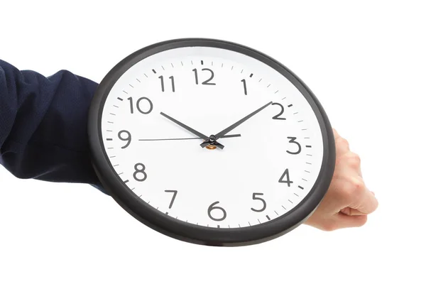 Businessman hand holding wall clock, time management Stock Picture