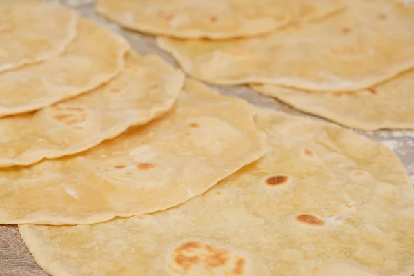 Stack of homemade whole wheat flour tortilla on wooden table — Stock Photo, Image