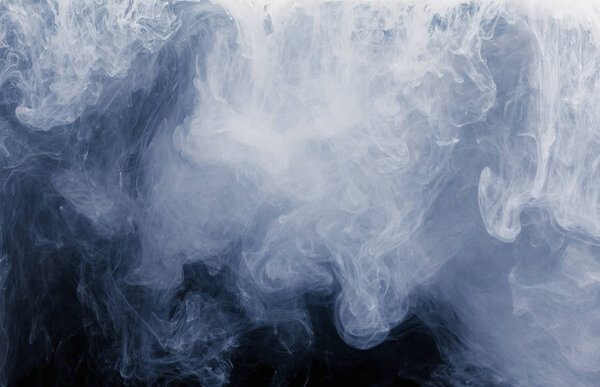 Abstract of white smoke pattern on a black background.