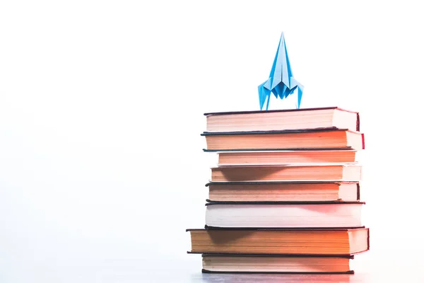 Back to school concept rocket is on books. Idea of knowledge and aspirations in a career, white background — Stock Photo, Image