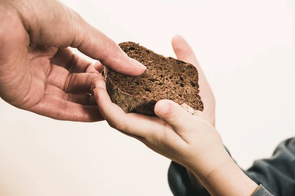 Two beggar hands palms with cheap bread. Poor children and people donations Volunteers Concept. — Stock Photo, Image