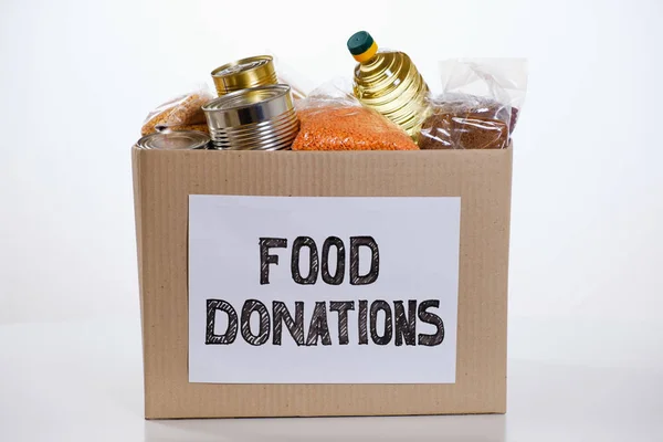 Alimentos em caixa de papelão de doação, isolados sobre fundo branco — Fotografia de Stock