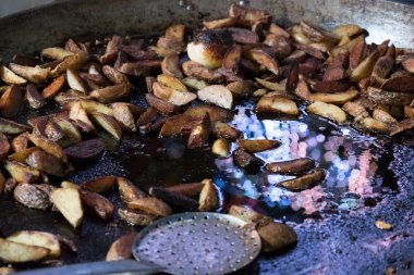 Kızarmış patateslerin üzerine büyük bir kızartma tavası, fast food.