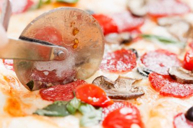 Özel bıçakla dilimlenmiş pepperonili pizza..