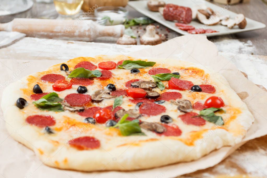 Assorted pizza with different fillings served on wooden table with ingredients