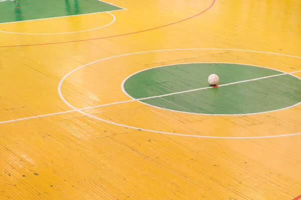 Football or futsal stadium with a bright markup of the playing field and ball in center. Top View.