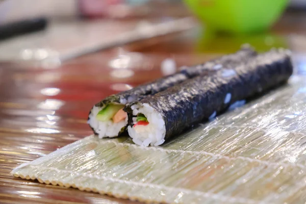 Sushi roll making, close up on table