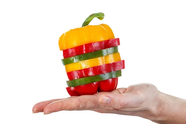 A selection of colorful sweet peppers sliced in pieces to make one pepper on hand — Stock Photo, Image