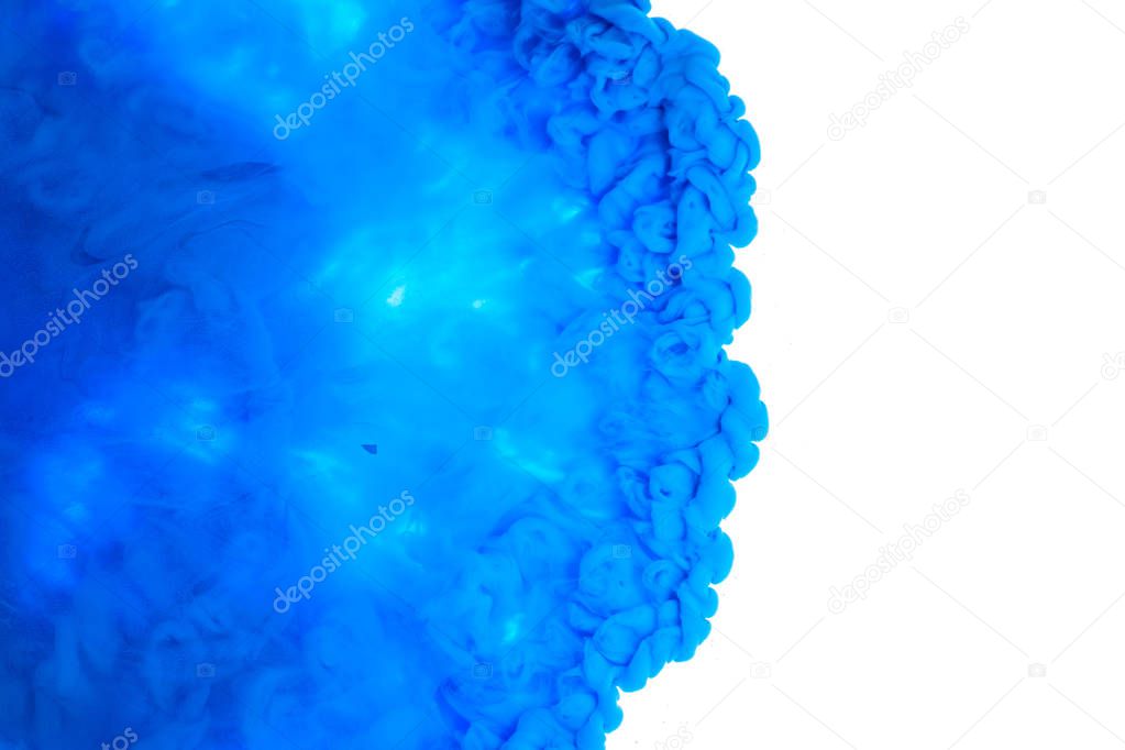 Color drop in water, photographed in motion. Ink swirling. Cloud of silky ink under water isolated on white background. Colorful ink in water, ink drop.