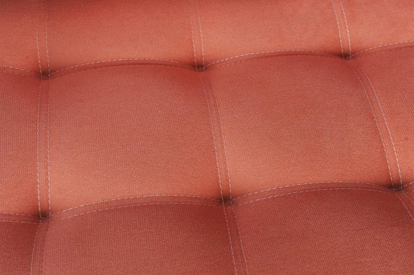Tekstura tkanina pomarańczowy sofa z firmware — Zdjęcie stockowe