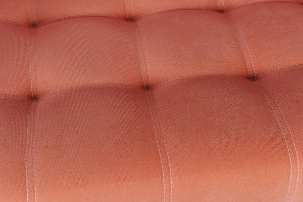 Sofá de tecido de textura laranja com firmware — Fotografia de Stock