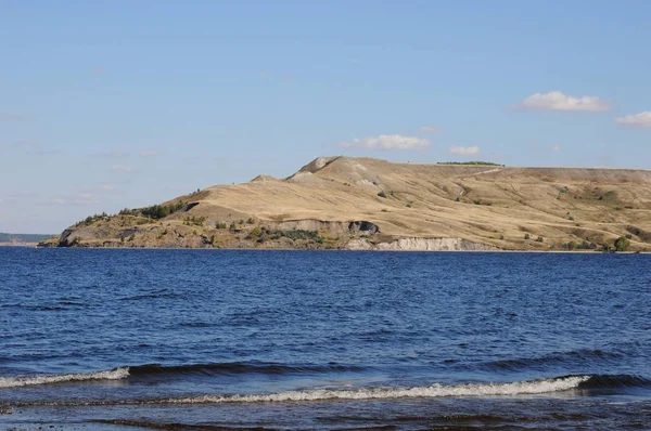 Landschap door het water. Eiland aan de andere kant. Baai, blauwe water met golven. Rivier of zee — Stockfoto