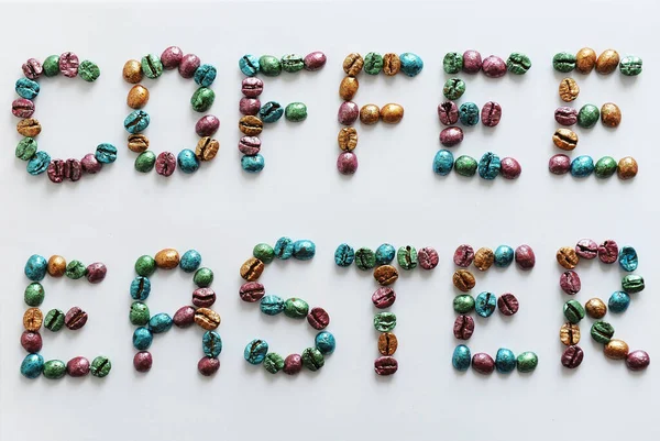 Coffee Easter. Lettering made of multi-colored pearl coffee beans on white background.