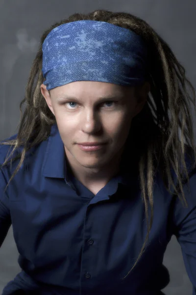 Man's portrait with colorful dreadlocks, hippie style. Stock Image