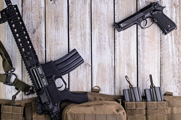 Rifle,gun and army belt with ammo on table