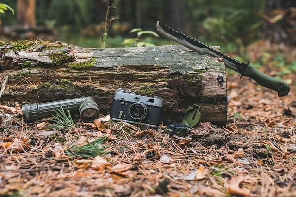 Old camera,flashlight compass and machete.Selective focus — Stock Photo, Image