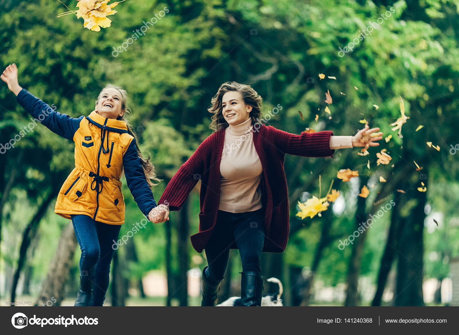 Two Sisters Holding Hands While Walking In The Autumn Park. — Stock - 1600x1167 - jpeg Two Sisters Holding Hands