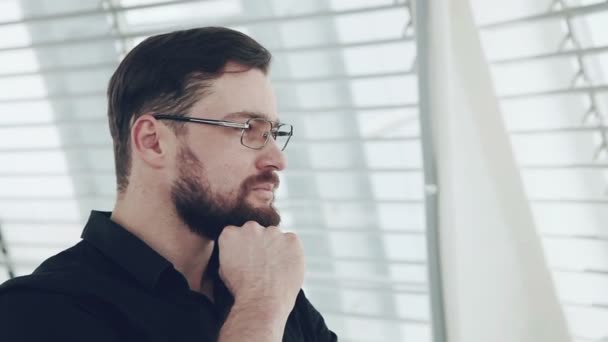 Joven empresario mirando por la ventana — Vídeo de stock