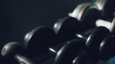 Atlet bir dumbbell eğitim alır. Halter salonunda.