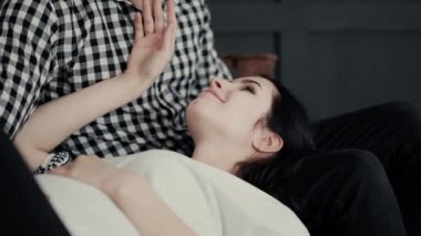 attractive brunette in white blouse kisses happy husband