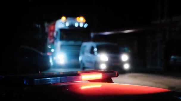 Cars with flashing lights drive along road at dark night — Stock Video