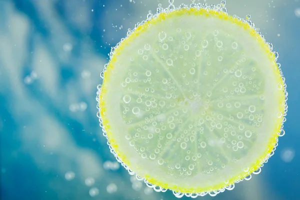 Lemon in carbonated water Stock Picture