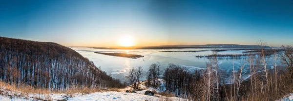 Panoramic view on frozen Volga river in winter during sunset from hill near Samara city