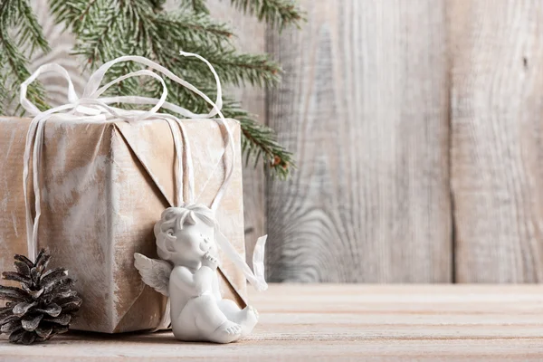 Рождественский фон с подарочной коробкой и ангелочком — стоковое фото