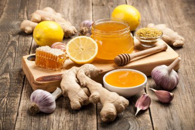 Healthy food table with honey, ginger, garlic and lemon clipart