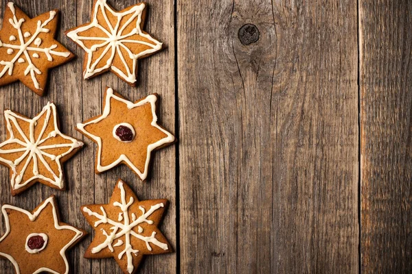 Christmas gingerbread cookies on wooden background — Stock Photo, Image