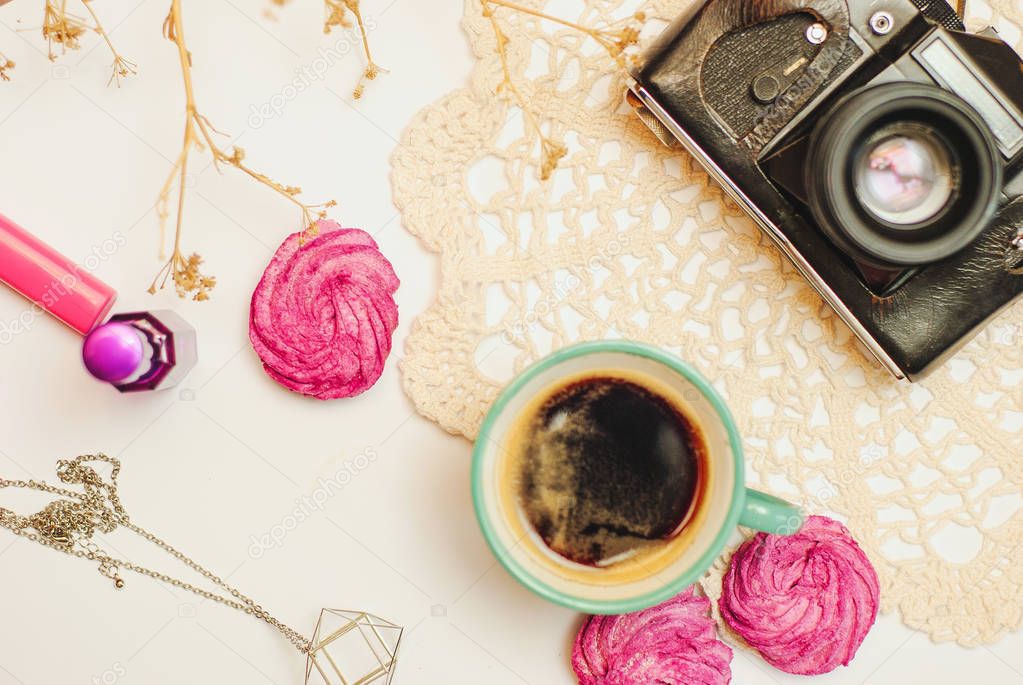 flat lay- desk with coffee, zephyr, vintage camera and cosmetics