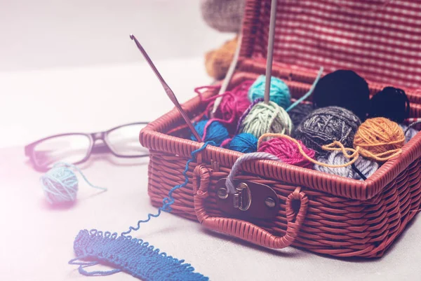 beautiful still life with clews wool yarn in a basket