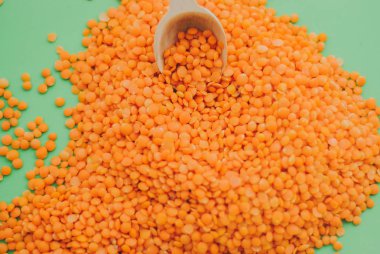 Red lentil in wooden spoon