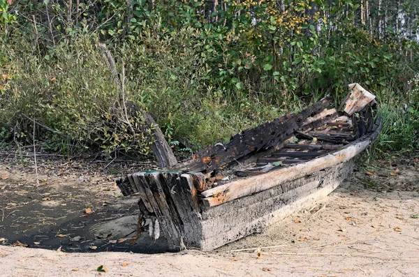 Velho barco de madeira abandonado no lago — Fotografia de Stock