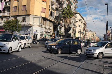 Naples, ITALY, January 05, 2017: Disorderly traffic in the center of the city. Each driver strives to cross the intersection first clipart