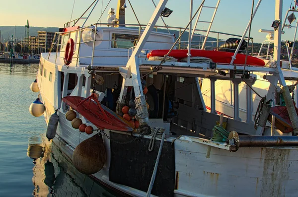 Primo piano della vecchia barca da pesca ormeggiata nel porto di Koper. Ormeggio del piccolo peschereccio al molo. Attrezzatura e attrezzatura da pesca sulla barca. Autunno paesaggio mattutino. Koper, Slovenia — Foto Stock