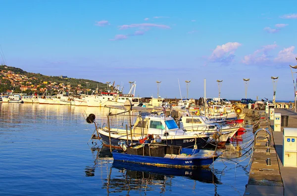 Koper, Slovenia-September 29, 2019: Moored fishing boats in harbor of Koper. Mooring of the small fishing vessel at the dock. Fishing gear and equipment on the boat. Autumn morning landscape — Stock Photo, Image
